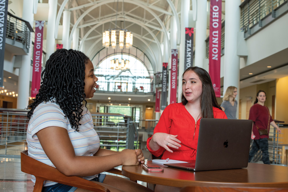 two women talking at table in Ohio Union
