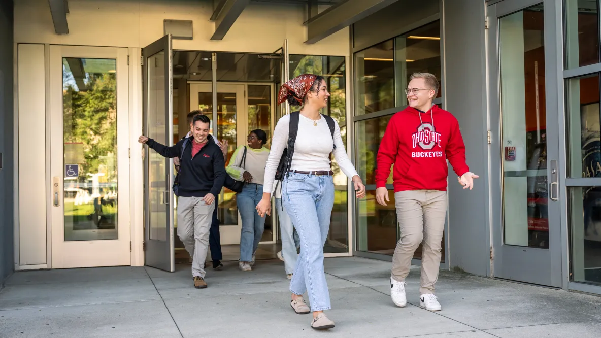 Smiling students exit Cunz Hall